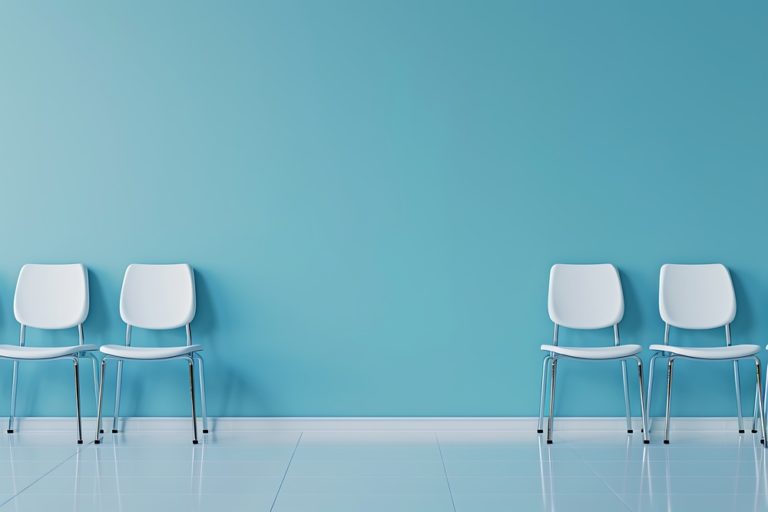 Sala de espera com paredes azuis e cadeiras brancas, representando a importância de reduzir o tempo de espera